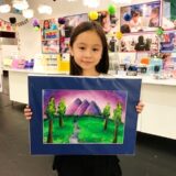 Girl holding painting