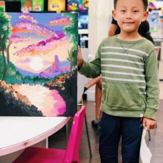 image of student holding artwork of scenery