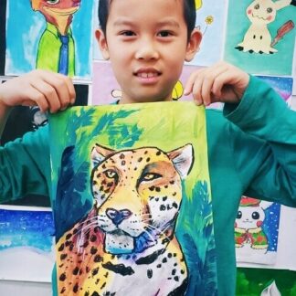 image of student holding artwork of leopard