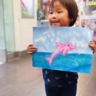 student showing art pink dolphin