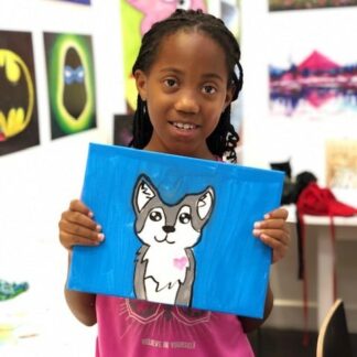 student showing art puppy