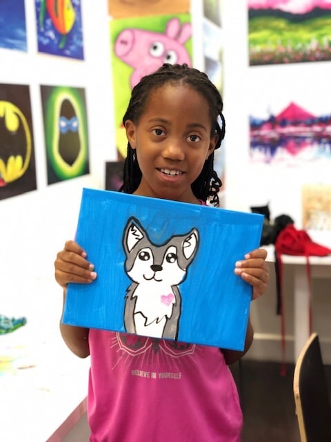 student showing art puppy