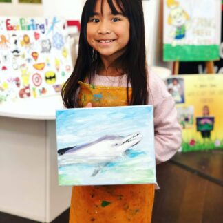 student showing art dolphin