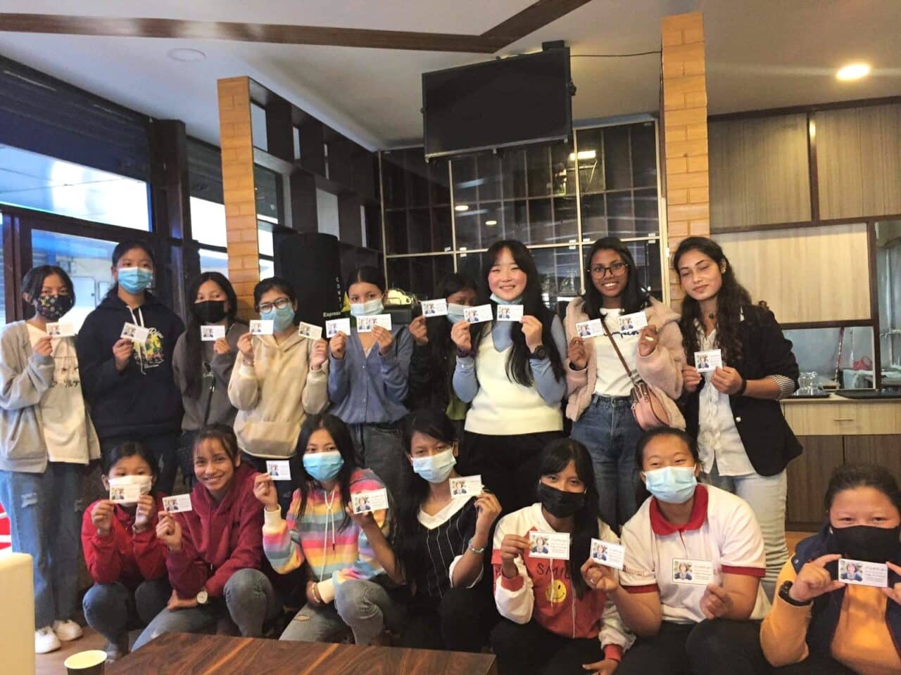 image of a group of women holding pieces of paper in front of them
