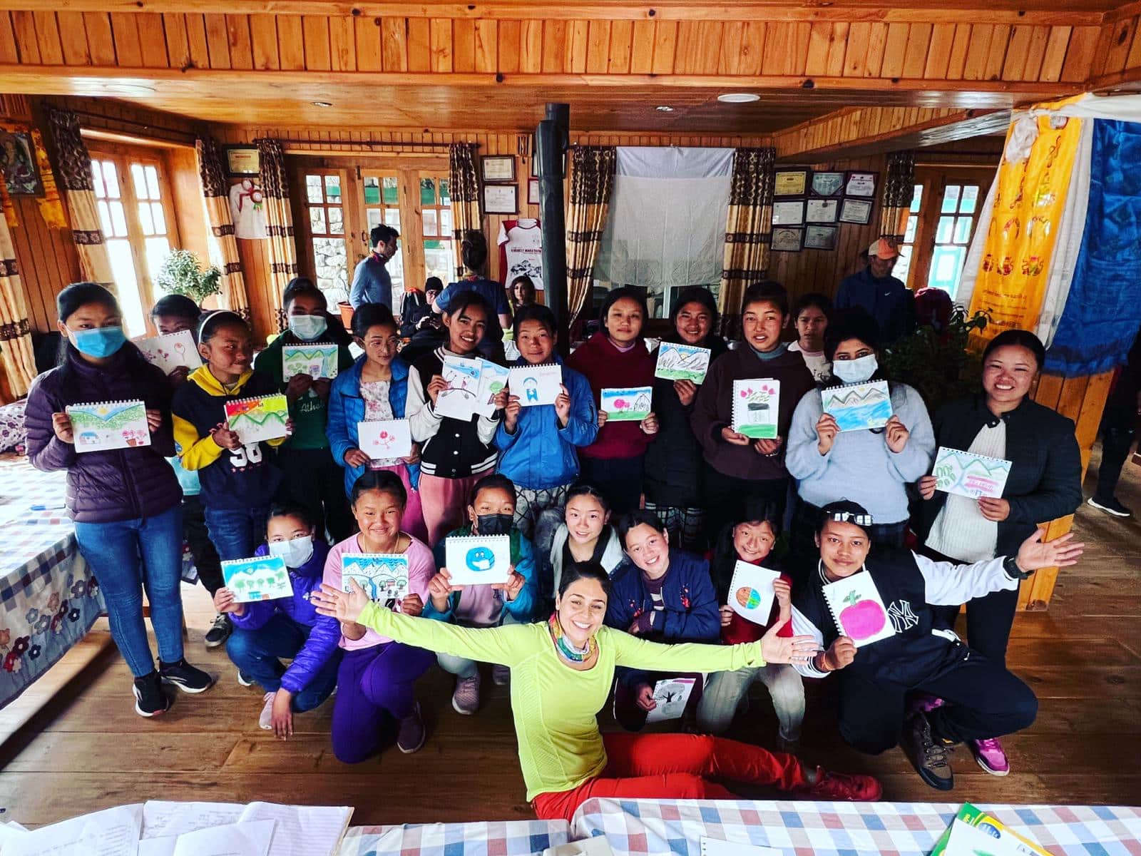 image of a group of students standing together holding their artwork