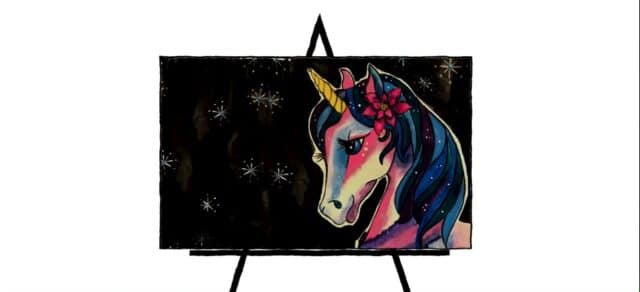 colorful unicorn drawing on easel
