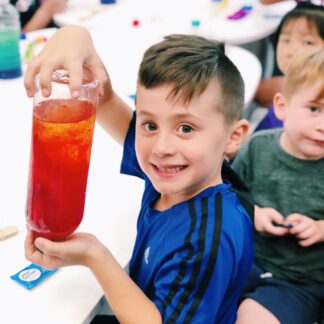 boy holding homemade lava lamp