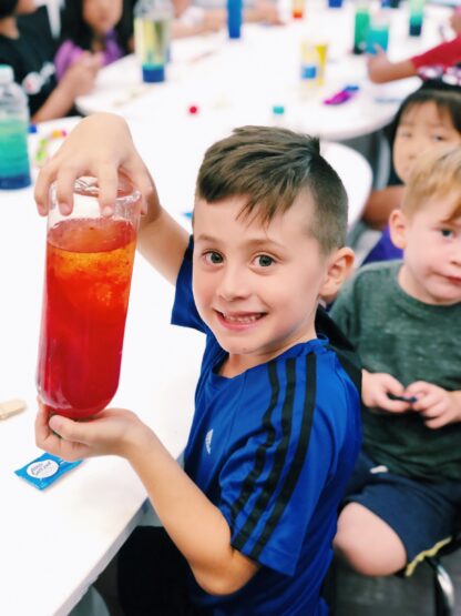 boy holding homemade lava lamp