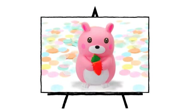 pink sculpture of a pink bunny holding a carrot
