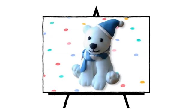 clay sculpted white polar bear with blue hat and blue and white scarf