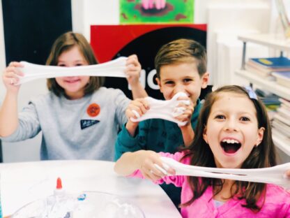 kids smiling and stretching slime