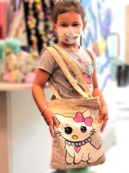 girl holding hello kitty tote bag