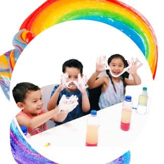 students playing with slime and rainbow like background