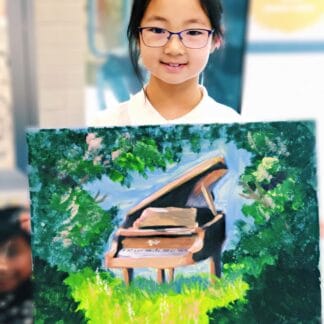 a girl holding her painting of a piano