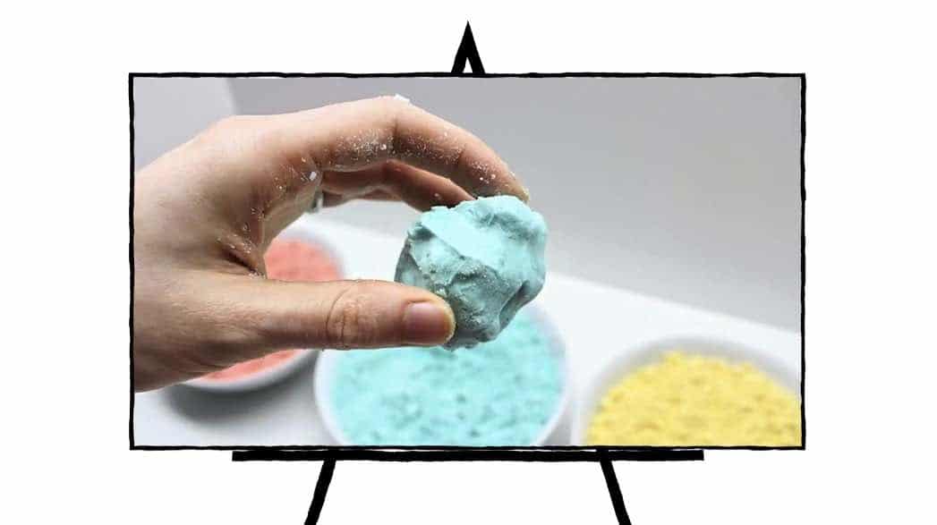 hand holding blue colored sand
