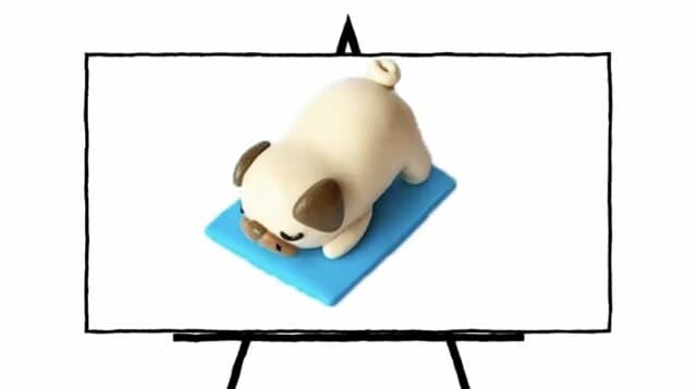 image of a pug made of clay laying on blue mat