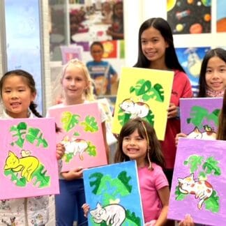 image of a group of girls holding canvas paintings of cats