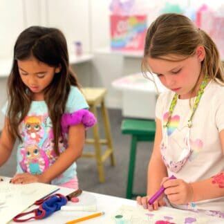image of 2 students painting at a birthday party