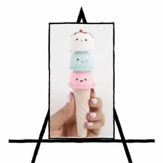 image of hand holding an ice cream cone with 3 scoops of ice cream with faces