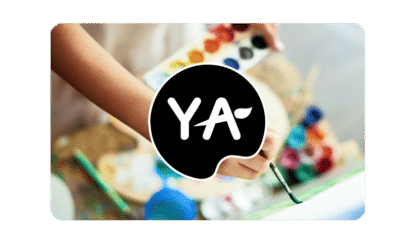 young art logo on gift card image with paint, brushes and hand in background