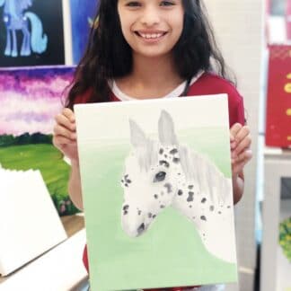 girl holding canvas painting go white horse with black spots