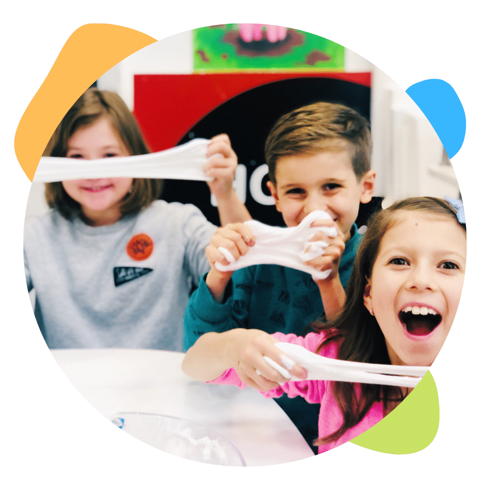 image of 3 kids stretching slime and smiling