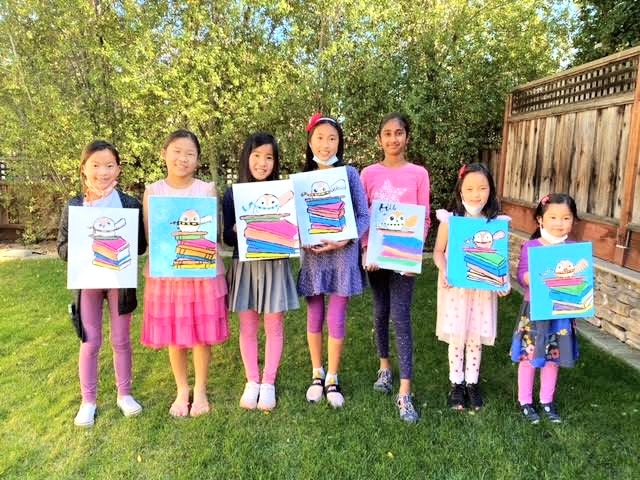 picture of kids holding their paintings