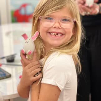 a girl holding her art piece