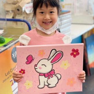 a girl holding her art piece
