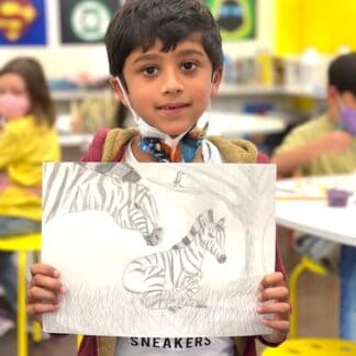 picture of a boy holding a pencil sketch of a zebra