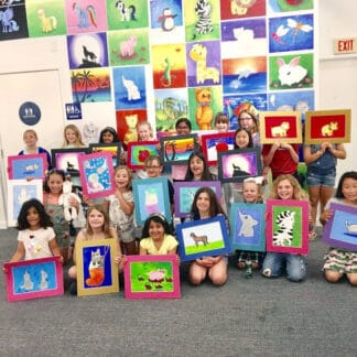 kids holding their painting creations