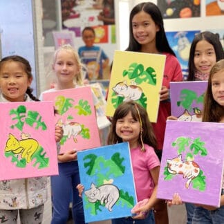 kids holding their painting creations