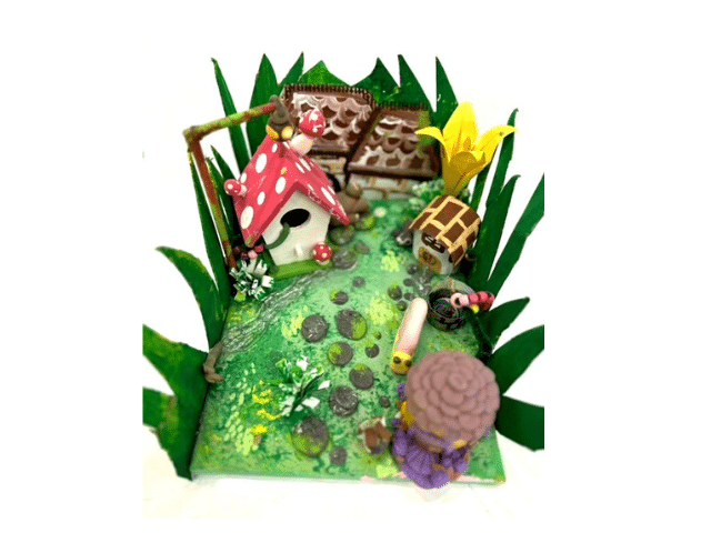 image of a canvas decorated to make a forest scene with clay creatures