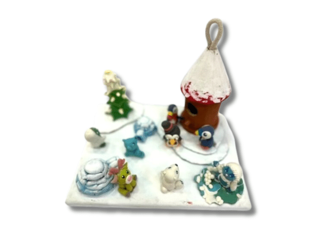 image of a canvas decorated to make a winter scene with clay creatures