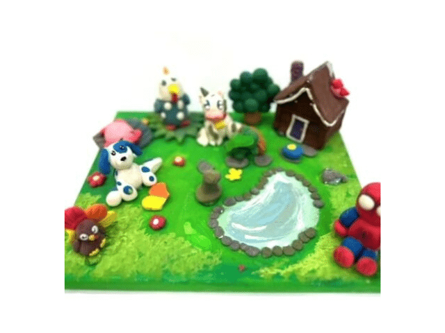 image of a canvas decorated to make a spring scene with clay creatures