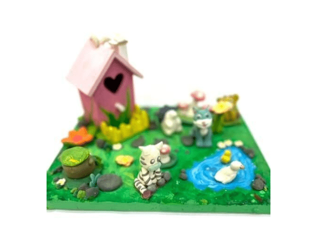 image of a canvas decorated to make a spring scene with clay creatures