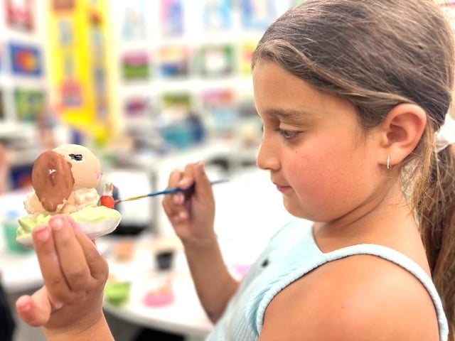 image of a young girl painting her 3d print