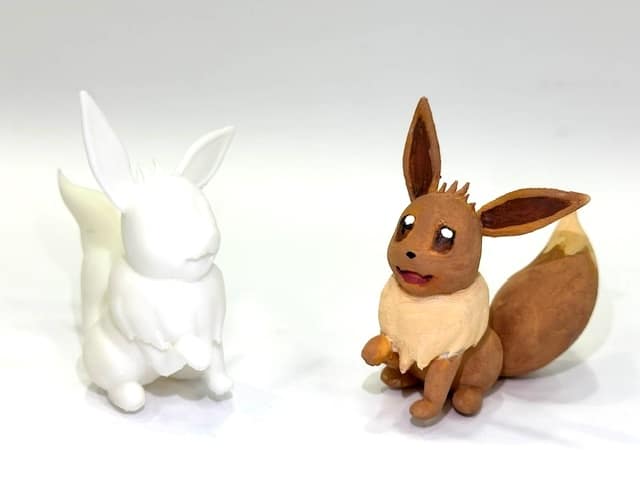 image of two different 3d printed scul[tures of Pokemon character eevee