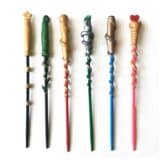 image of 6 different wands all in different colors and decorated with clay