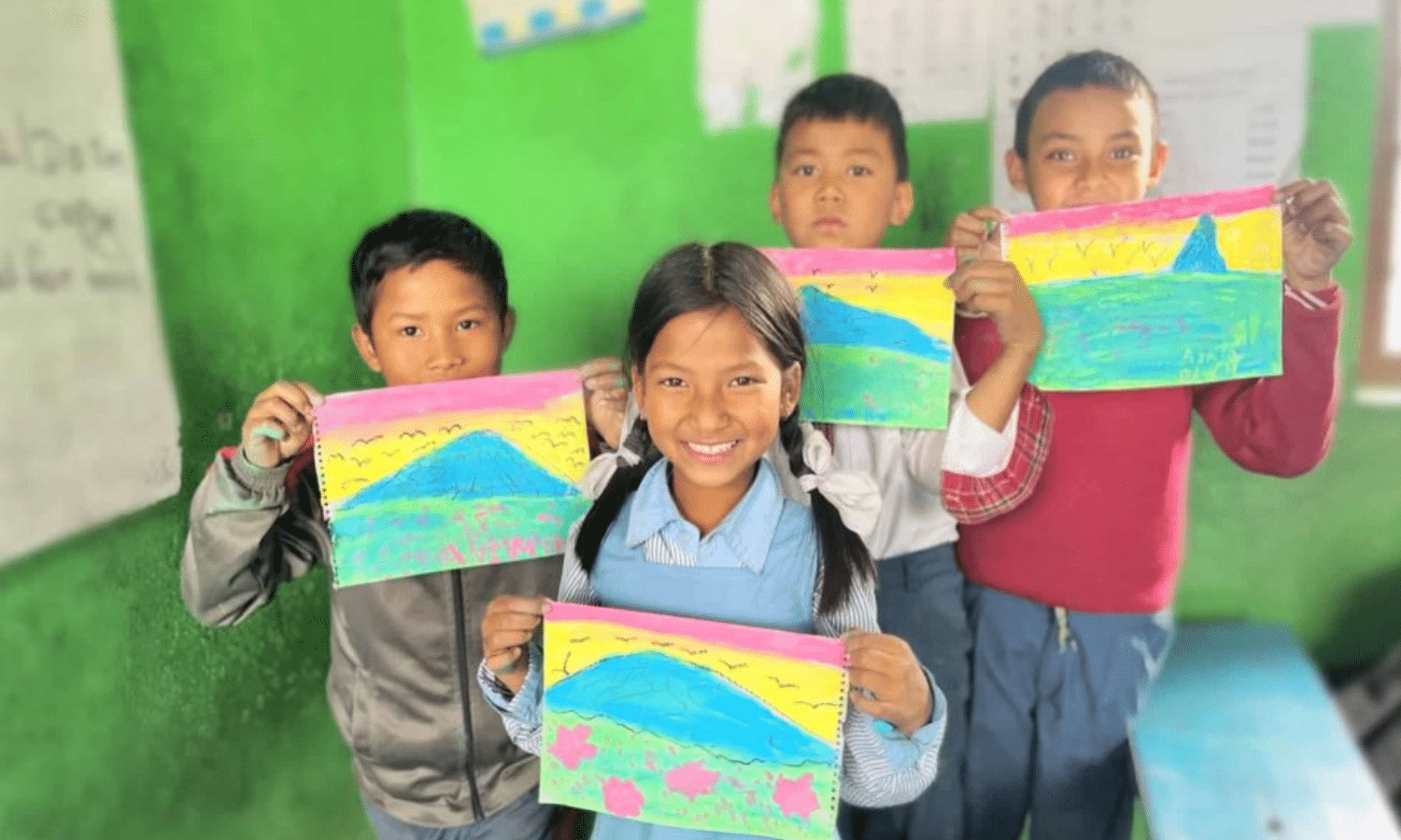 image of 4 kids standing in front of a green wall holding paintings of colorful fields in front of them