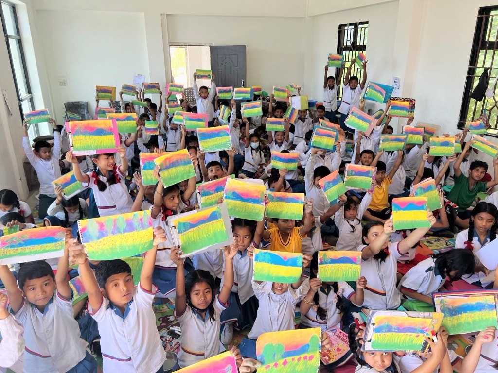 image of kids holding up sunset paintings
