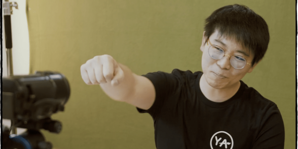 image of a teacher fist bumping a camera